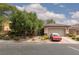 Charming single-story home featuring a two-car garage, stone accents, and mature trees in a well-kept yard at 7126 Mirkwood Ave, Las Vegas, NV 89178