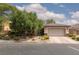Charming single-story home featuring a two-car garage, desert landscaping, and stone accents at 7126 Mirkwood Ave, Las Vegas, NV 89178