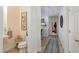 Bright hallway leads to a half bathroom and office space with neutral paint and tile flooring at 7126 Mirkwood Ave, Las Vegas, NV 89178