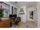 Bright home office with dual monitors, wood desk, and natural light from multiple windows at 7126 Mirkwood Ave, Las Vegas, NV 89178
