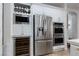 Modern kitchen with stainless steel appliances, including refrigerator, wine cooler, and double oven at 7126 Mirkwood Ave, Las Vegas, NV 89178