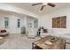 Open concept living room featuring neutral tones, tile entry, and a large sectional sofa with a wooden coffee table at 7126 Mirkwood Ave, Las Vegas, NV 89178