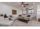 Spacious living room featuring neutral tones, a ceiling fan, decorative wood art, and a comfortable sectional at 7126 Mirkwood Ave, Las Vegas, NV 89178