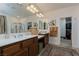 Well-lit main bathroom featuring dual sinks, walk-in shower, and walk-in closet at 7126 Mirkwood Ave, Las Vegas, NV 89178