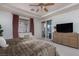 Bright main bedroom with neutral colors, custom drapery, access to the pool, and a large dresser at 7126 Mirkwood Ave, Las Vegas, NV 89178