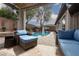 Relaxing backyard patio with pool view, comfortable lounge seating under a pergola and manicured landscape at 7126 Mirkwood Ave, Las Vegas, NV 89178