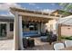 Inviting covered patio featuring a comfortable seating area and an outdoor kitchen, perfect for entertaining at 7126 Mirkwood Ave, Las Vegas, NV 89178
