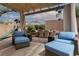 Cozy backyard patio with playhouse, seating under a pergola, ideal for relaxing and enjoying the outdoors at 7126 Mirkwood Ave, Las Vegas, NV 89178