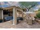 Outdoor patio with a pergola, comfortable seating, dining area, TV, and lush landscaping, perfect for relaxation at 7126 Mirkwood Ave, Las Vegas, NV 89178