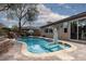 Beautiful backyard pool with lovely patio, cascading rock waterfall feature and basketball hoop at 7126 Mirkwood Ave, Las Vegas, NV 89178