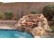 Close-up of the rock waterfall feature in the pool area at 7126 Mirkwood Ave, Las Vegas, NV 89178