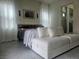 Cozy bedroom featuring a comfortable sofa, tiled floors, and natural lighting at 782 Omaggio Pl, Henderson, NV 89011