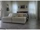 Bedroom featuring a comfortable sofa, tiled floors, and natural lighting at 782 Omaggio Pl, Henderson, NV 89011