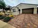 Charming single-story home with a well-manicured front yard and brick driveway at 782 Omaggio Pl, Henderson, NV 89011