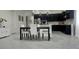 Stylish kitchen with modern black cabinets, a center island, and stainless steel appliances at 782 Omaggio Pl, Henderson, NV 89011
