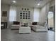 Bright living room featuring a large sectional sofa, tiled floors, and modern decor at 782 Omaggio Pl, Henderson, NV 89011