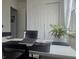 Bright workspace with a desk, computer, and indoor plant next to a window with white curtains at 782 Omaggio Pl, Henderson, NV 89011