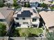 Aerial view of backyard with solar panels on roof, grass and privacy fence at 7821 Red Leaf Dr, Las Vegas, NV 89131