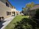 Backyard with green grass, a privacy fence, and a basketball hoop at 7821 Red Leaf Dr, Las Vegas, NV 89131
