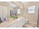 The bathroom features double sinks, a large mirror, natural light, and white cabinetry at 7821 Red Leaf Dr, Las Vegas, NV 89131