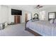 Spacious bedroom featuring a large TV, ceiling fan, and neutral carpet at 7821 Red Leaf Dr, Las Vegas, NV 89131
