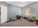 Bedroom with gray walls, carpet flooring, a window, and essential furnishings at 7821 Red Leaf Dr, Las Vegas, NV 89131