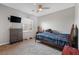 A bedroom with neutral walls features carpeting, a ceiling fan, and a bed at 7821 Red Leaf Dr, Las Vegas, NV 89131