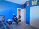 Cozy bedroom with blue walls, carpet floors, and motivational decor at 7821 Red Leaf Dr, Las Vegas, NV 89131