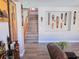 Inviting entryway showcasing hardwood floors, staircase, and decorative African artwork on the walls at 7821 Red Leaf Dr, Las Vegas, NV 89131
