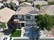 Aerial view of a two-story home with a three-car garage, and desert landscaping at 7821 Red Leaf Dr, Las Vegas, NV 89131