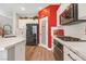 A well-equipped kitchen with a pantry, stainless steel appliances, and white cabinetry at 7821 Red Leaf Dr, Las Vegas, NV 89131
