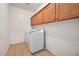 Laundry room with tile flooring, upper cabinets, and a washer and dryer set at 7821 Red Leaf Dr, Las Vegas, NV 89131