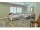 Spacious living room featuring a large sectional sofa, ceiling fan and wood look flooring at 7821 Red Leaf Dr, Las Vegas, NV 89131