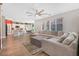 Spacious living room offering hardwood flooring, neutral walls, large sectional, and natural light at 7821 Red Leaf Dr, Las Vegas, NV 89131