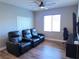 Media room featuring reclining chairs, a large window and mounted tv at 7821 Red Leaf Dr, Las Vegas, NV 89131