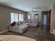 Spacious living room featuring a large sectional sofa, ceiling fan and wood look flooring at 7821 Red Leaf Dr, Las Vegas, NV 89131