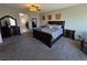 Spacious main bedroom featuring carpet floors, a large bed, and decorative furniture at 7821 Red Leaf Dr, Las Vegas, NV 89131