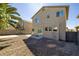 Back of house featuring gravel, concrete pads, block wall and mature palm trees at 7836 Pinnochio Ave, Las Vegas, NV 89131