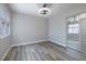 Spacious bedroom featuring new vinyl floors, ceiling fan, window and mirrored closet at 7836 Pinnochio Ave, Las Vegas, NV 89131