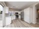 Well-lit kitchen with white cabinets, stainless steel appliances, and access to the backyard at 7836 Pinnochio Ave, Las Vegas, NV 89131