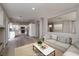 Bright living room features an open floor plan with a view of the kitchen and neutral color palette at 7836 Pinnochio Ave, Las Vegas, NV 89131