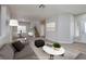 Open living room and dining area with a staircase and light-colored wood floors at 7836 Pinnochio Ave, Las Vegas, NV 89131