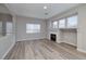 Cozy living room showcasing a fireplace, new floors and many windows for natural light at 7836 Pinnochio Ave, Las Vegas, NV 89131
