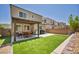 Beautiful backyard with artificial turf, a built-in barbeque, and a shaded patio area at 8055 Tank Loop St, Las Vegas, NV 89166