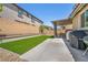 Backyard with artificial turf lawn, BBQ and covered patio, perfect for outdoor living at 8055 Tank Loop St, Las Vegas, NV 89166
