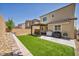 Spacious backyard features a covered patio, artificial grass, and barbecue area at 8055 Tank Loop St, Las Vegas, NV 89166