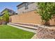 Backyard featuring tiered landscaping, a retaining wall and artificial turf at 8055 Tank Loop St, Las Vegas, NV 89166