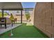Putting green adjacent to the covered patio, with a view of the backyard at 8055 Tank Loop St, Las Vegas, NV 89166