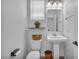 Cozy powder room with pedestal sink, decorative accents, and neutral tones at 8055 Tank Loop St, Las Vegas, NV 89166