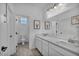 Well-lit bathroom featuring a double vanity, a toilet, and stylish decor, creating a functional and inviting space at 8055 Tank Loop St, Las Vegas, NV 89166
